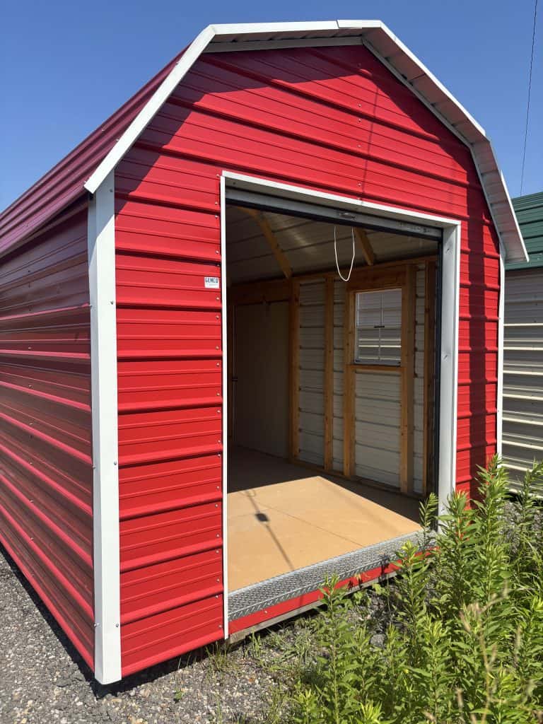 High-quality metal storage building with red exterior siding and white trim, showcasing custom construction by GEMCO Buildings Inc. for durable, customizable storage solutions in various settings.