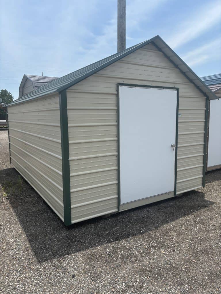 Portable metal storage shed with beige siding, white door, and green trim, ideal for commercial or residential storage solutions by GEMCO Buildings, Inc.